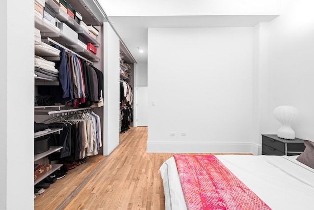 bedroom featuring a closet, baseboards, and wood finished floors