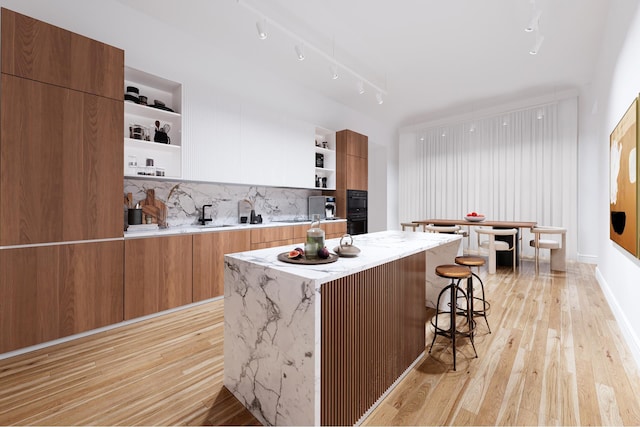 kitchen featuring open shelves, light wood-type flooring, and modern cabinets