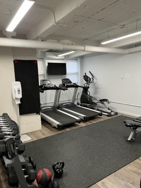 exercise room featuring wood finished floors