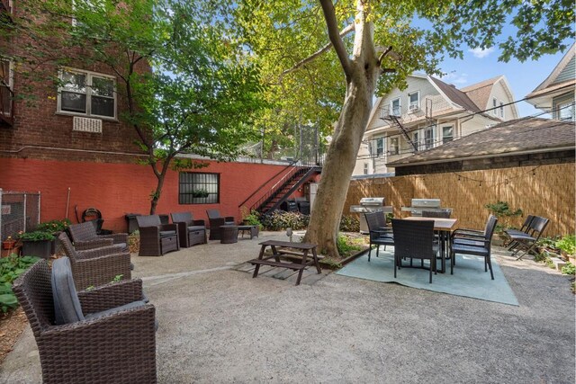 view of patio / terrace with fence, stairway, and outdoor dining area