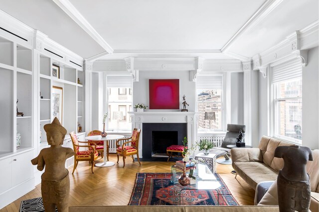 interior space featuring ornamental molding, a raised ceiling, and light wood-type flooring