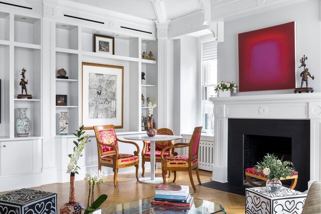 living room featuring crown molding and parquet flooring