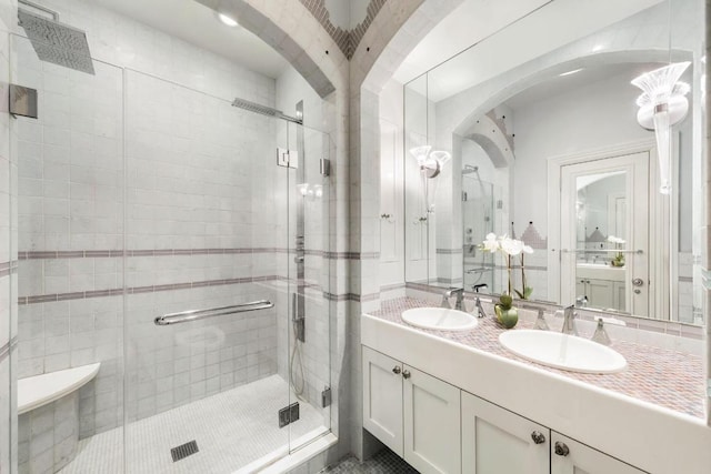 bathroom featuring vanity and a shower with shower door