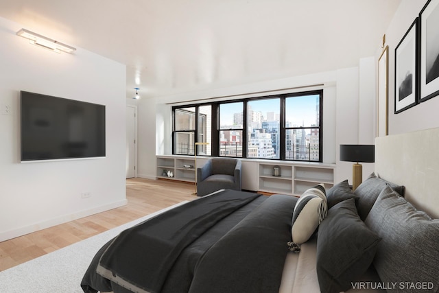 120 E 90th St Unit 15Ade, New York City, NY 10128 - bedroom with wood finished floors, a view of city, and baseboards