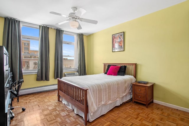 bedroom featuring a baseboard heating unit, a wall unit AC, light parquet floors, and ceiling fan