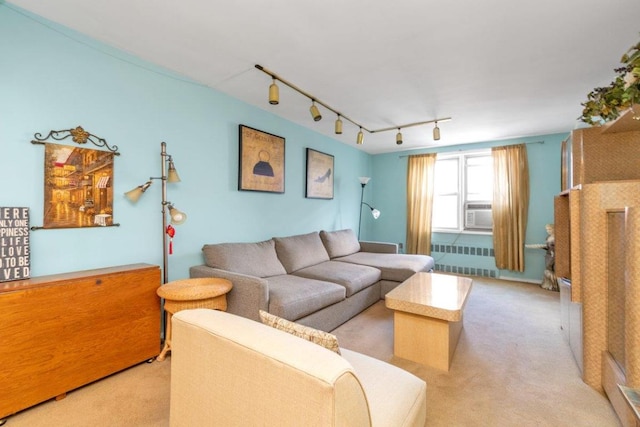 carpeted living room with cooling unit, track lighting, and radiator