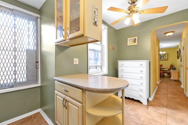 kitchen with light tile patterned floors and ceiling fan