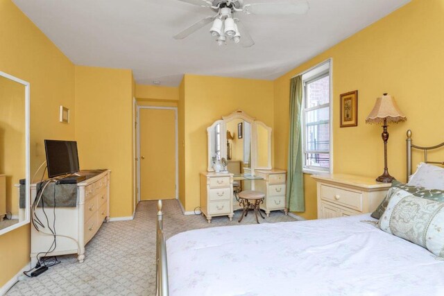 bedroom featuring ceiling fan and light colored carpet