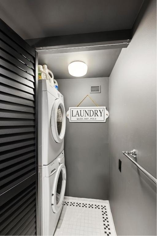 laundry area featuring stacked washer and clothes dryer