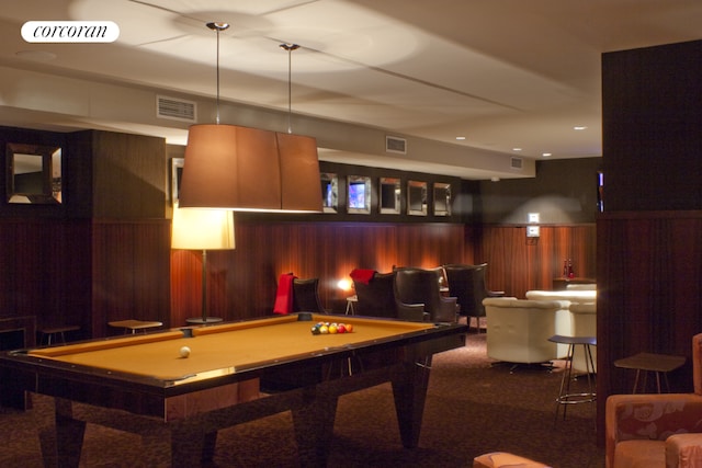 recreation room featuring wood walls, visible vents, and a wainscoted wall