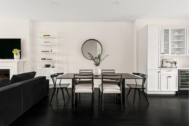 dining area featuring dark wood-type flooring and beverage cooler