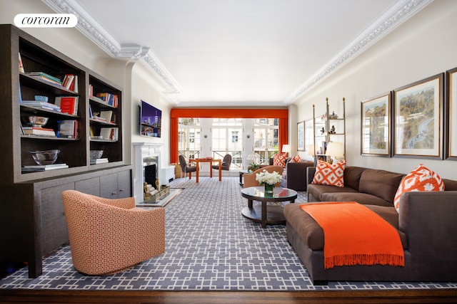 living room with built in shelves and ornamental molding