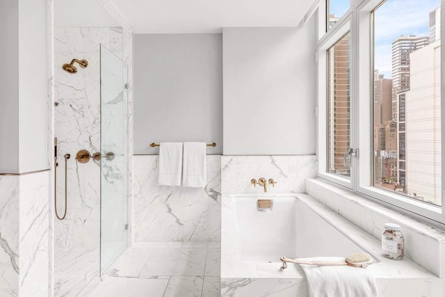 bathroom featuring tile walls, plus walk in shower, and a healthy amount of sunlight