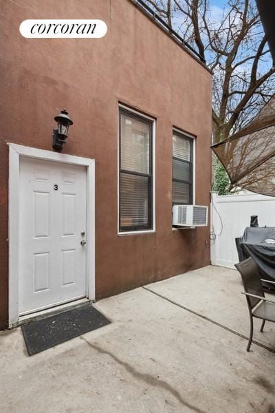 entrance to property with a patio area and cooling unit