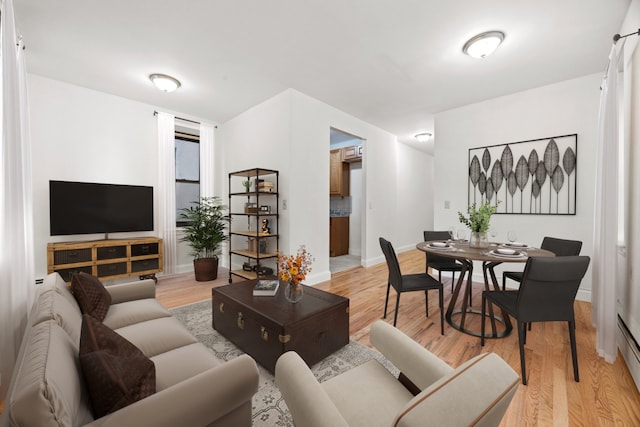 living area featuring light wood-style floors and baseboards