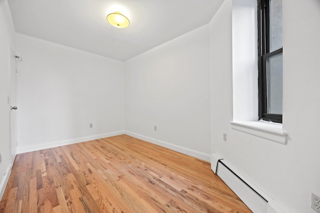 2090 Madison Ave Unit 1D, New York City, NY 10037 - empty room with baseboard heating, wood finished floors, and baseboards