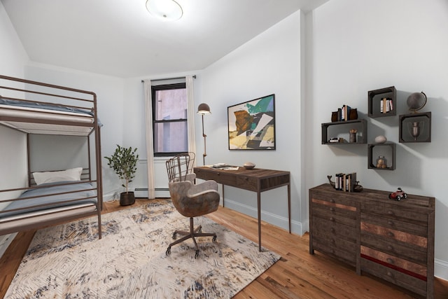 2090 Madison Ave Unit 1D, New York City, NY 10037 - bedroom featuring wood finished floors, a baseboard heating unit, and baseboards