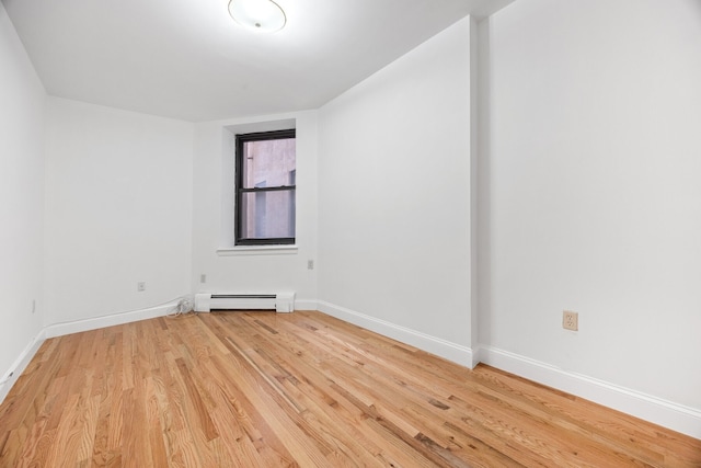2090 Madison Ave Unit 1D, New York City, NY 10037 - spare room with a baseboard radiator, light wood-style flooring, and baseboards