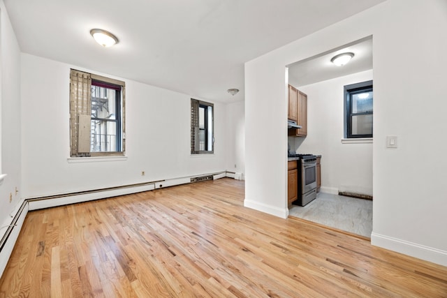 2090 Madison Ave Unit 1D, New York City, NY 10037 - unfurnished living room with light wood finished floors and baseboards
