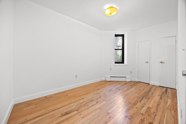 2090 Madison Ave Unit 1D, New York City, NY 10037 - unfurnished room with light wood-style flooring, a baseboard heating unit, and baseboards