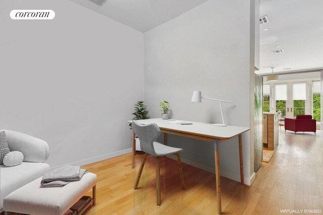 living room featuring sink and light hardwood / wood-style flooring