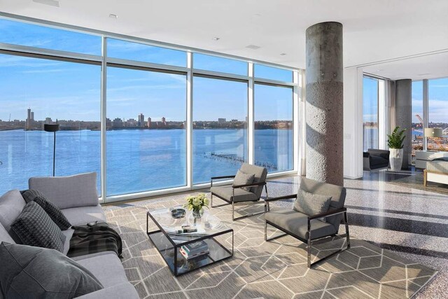 interior space featuring floor to ceiling windows and a water view