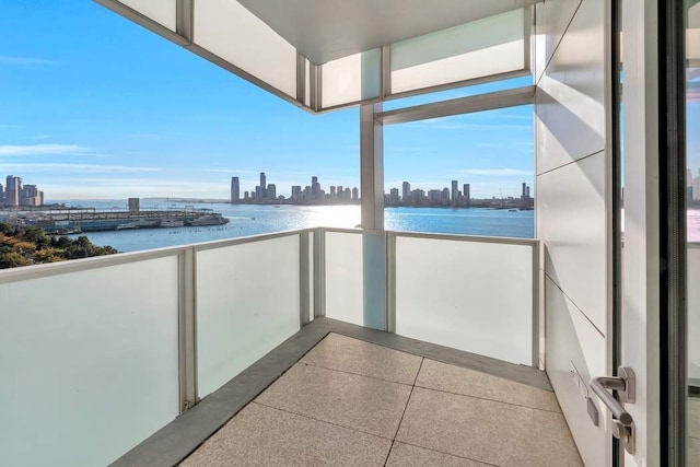 balcony with a water view and a city view