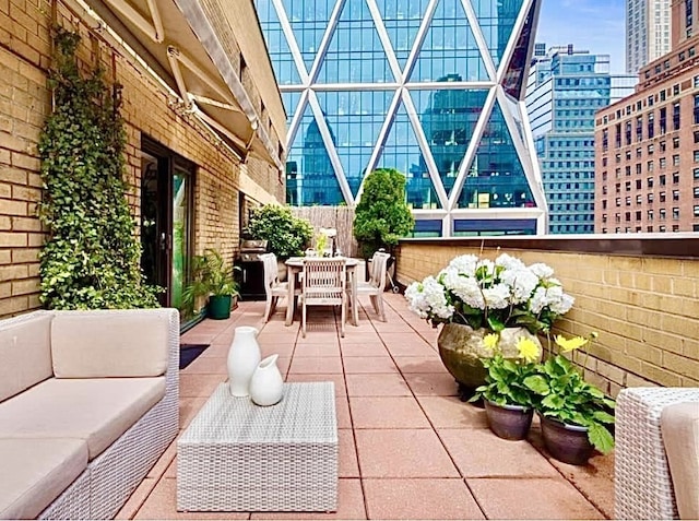 view of patio featuring a city view, an outdoor living space, and outdoor dining area