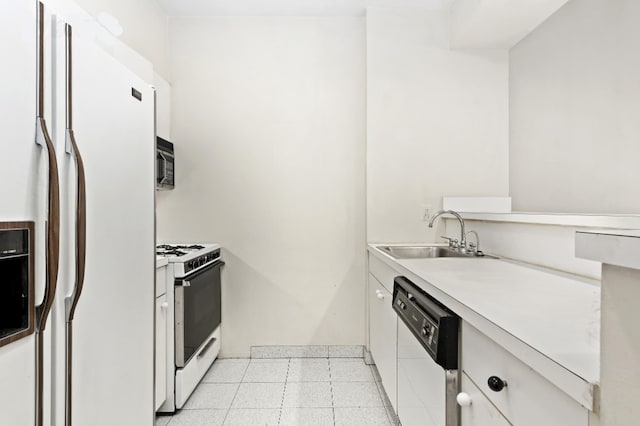 kitchen featuring sink, white cabinets, and white appliances