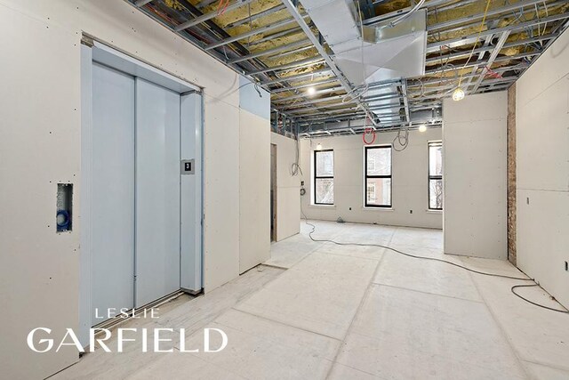 dining room with light wood-type flooring and elevator