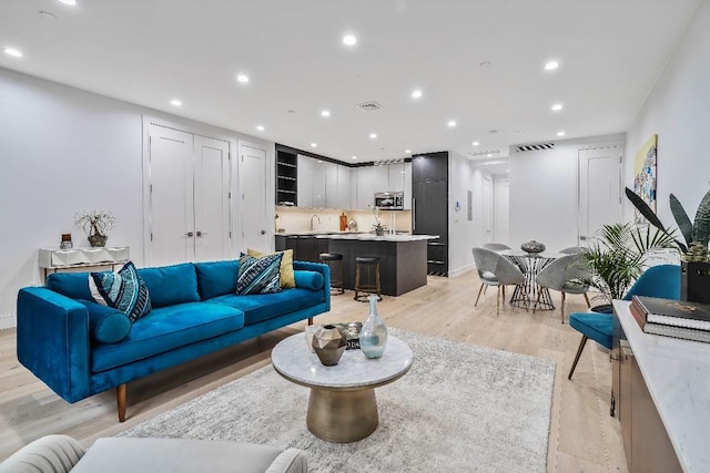 living room with light hardwood / wood-style flooring