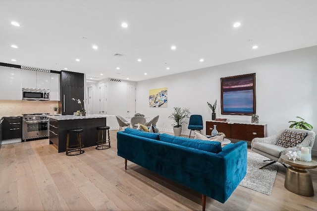 living room with light hardwood / wood-style flooring