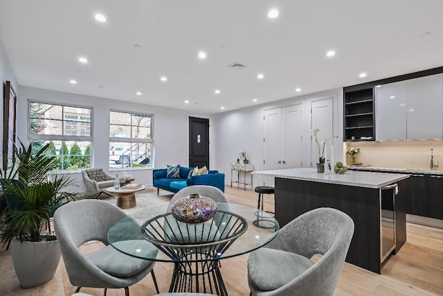 dining space featuring light hardwood / wood-style floors and sink