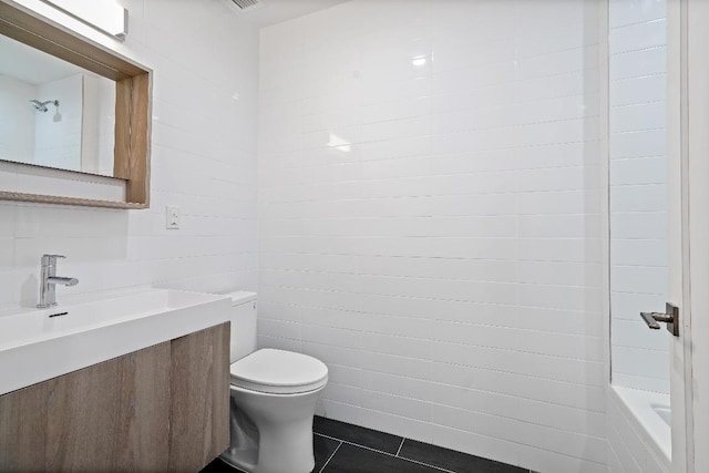 bathroom featuring toilet, vanity, and tile patterned flooring