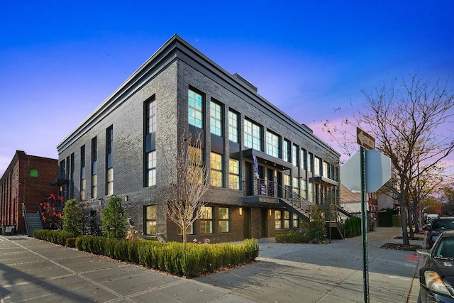 view of outdoor building at dusk