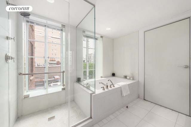 bathroom featuring independent shower and bath and tile patterned flooring