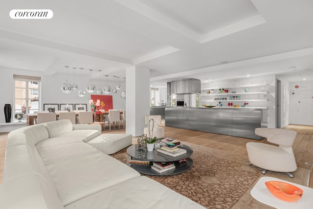 living room featuring beam ceiling and light wood-type flooring