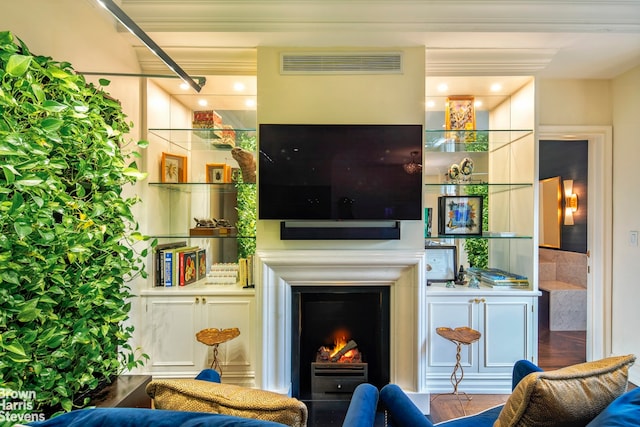 living room featuring visible vents and a warm lit fireplace