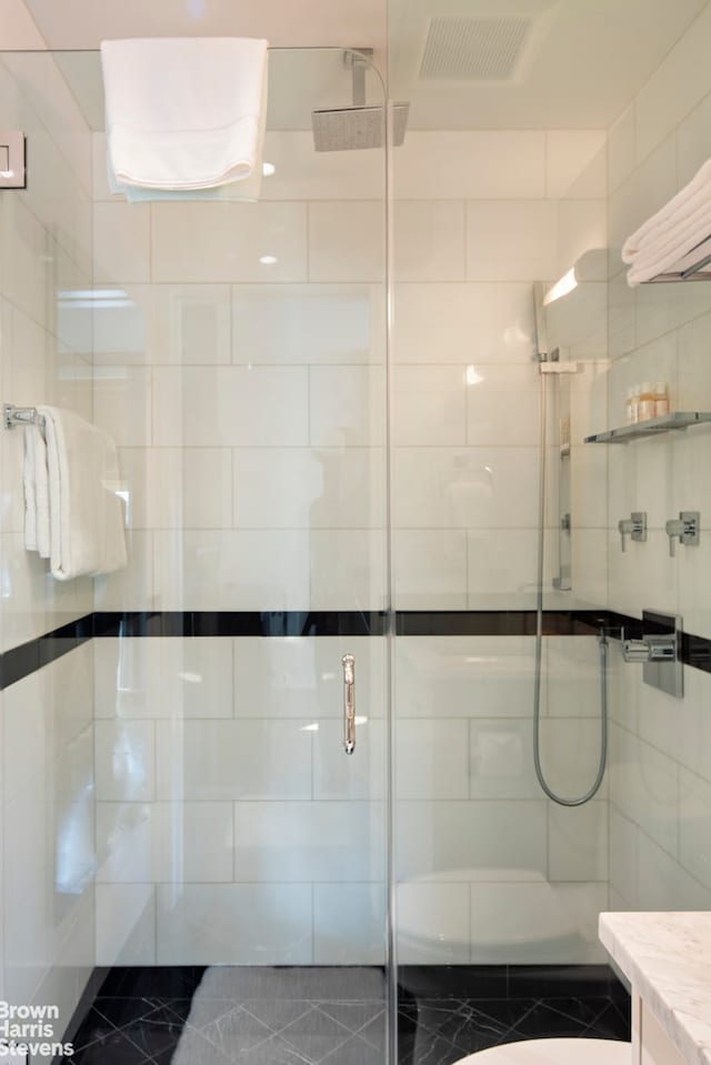 full bath featuring visible vents, a shower stall, tile walls, and vanity