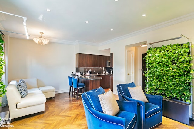 living area with recessed lighting, baseboards, an inviting chandelier, and ornamental molding