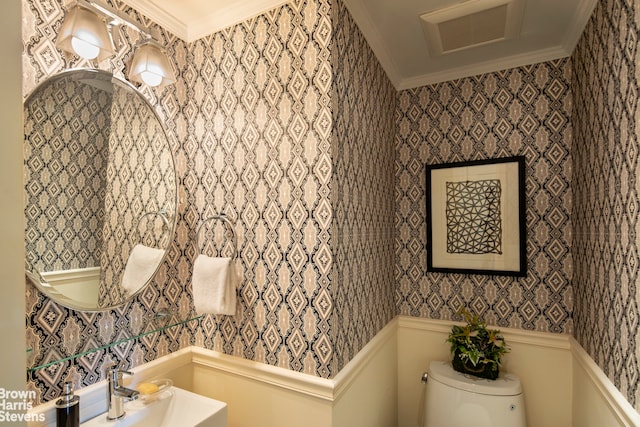 bathroom featuring wallpapered walls, crown molding, toilet, and visible vents