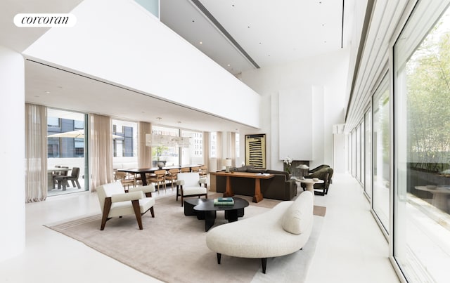 living room featuring a towering ceiling and expansive windows