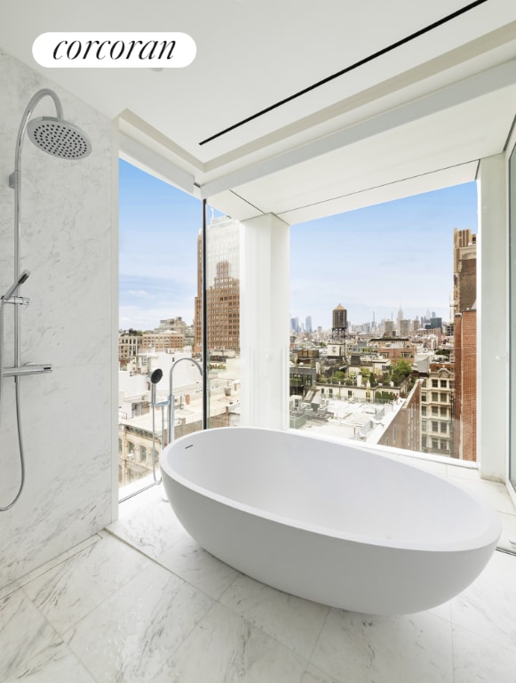 bathroom featuring a wall of windows and a tub to relax in