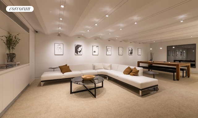 carpeted living room with beam ceiling