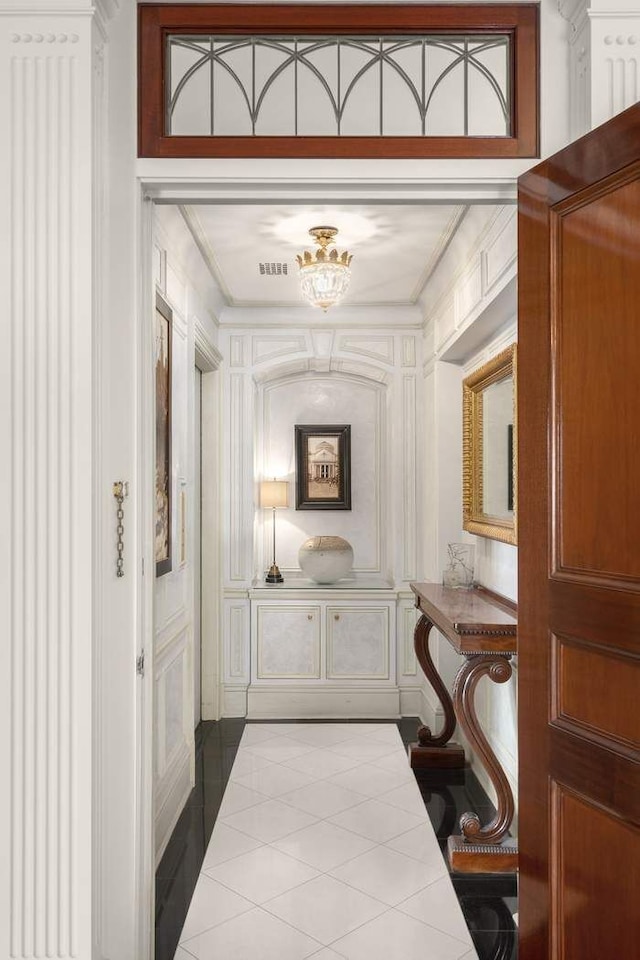 435 E 52nd St Unit 14G, New York City, NY 10022 - corridor with tile patterned floors and a chandelier