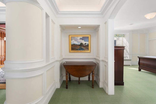 corridor featuring ornamental molding and carpet floors