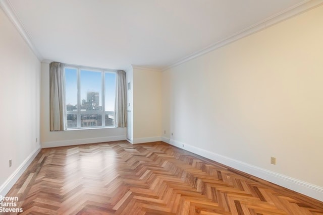 spare room featuring light parquet floors and crown molding