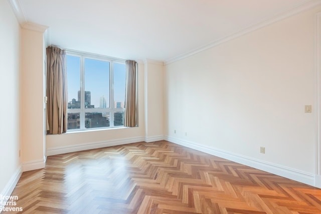 empty room with light parquet floors and crown molding