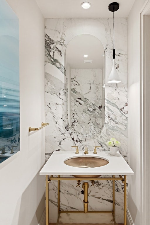 bathroom with tile walls and sink