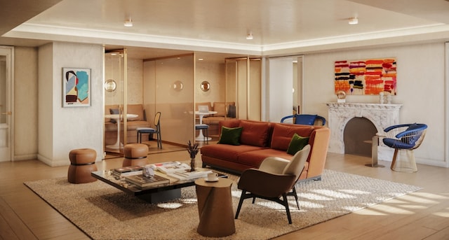 living room with a raised ceiling and light wood-type flooring